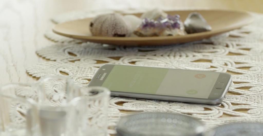 Smartphone ringing on a white crochet table cloth indicating a vishing cyber security attack.