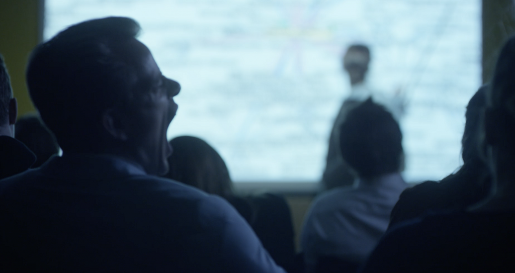 Man yawning at a lecture. The old way of doing cybersecurity awareness training.