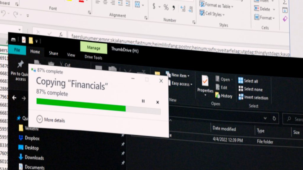 Snapshot from AwareGO's cybersecurity awareness video about malicious insider threat. A computer screen shows that financial data is being copied.